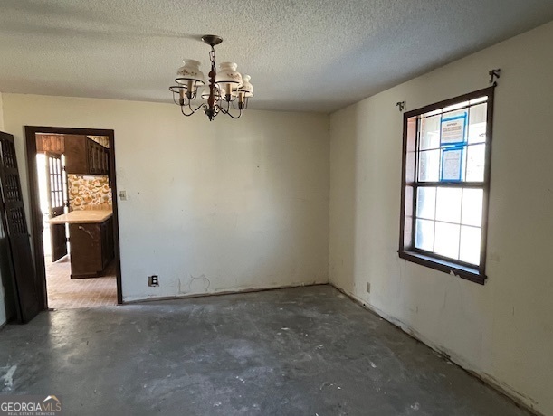 563 Keith Road Guyton, GA 31312 - Photo 9 of 13 an empty room with chandelier fan and windows