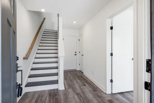 an empty room with wooden floor and window
