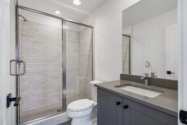 a kitchen with stainless steel appliances granite countertop a sink a stove and a wooden floors