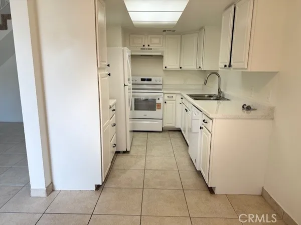 a kitchen with stainless steel appliances a sink and cabinets