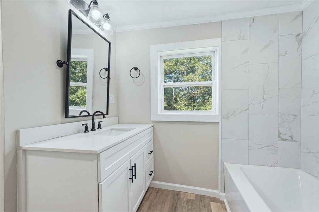 418 Old River Road Pelzer, SC 29669 - Photo 11 of 32 Elegant tile surrounds the soaking tub in this updated bathroom.