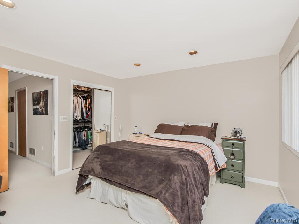 8 Davids Lane Ossining, NY 10562 - Photo 19 of 27 Bedroom with light colored carpet, a walk in closet, and recessed lighting