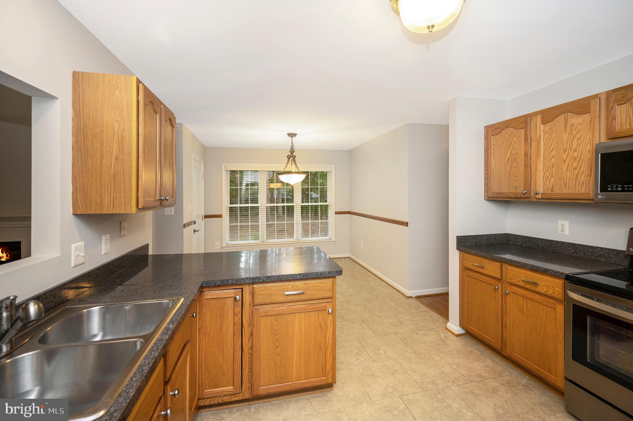 502 Monticello Circle Locust Grove, VA 22508 - Photo 12 of 45 a kitchen with stainless steel appliances granite countertop a sink and a stove