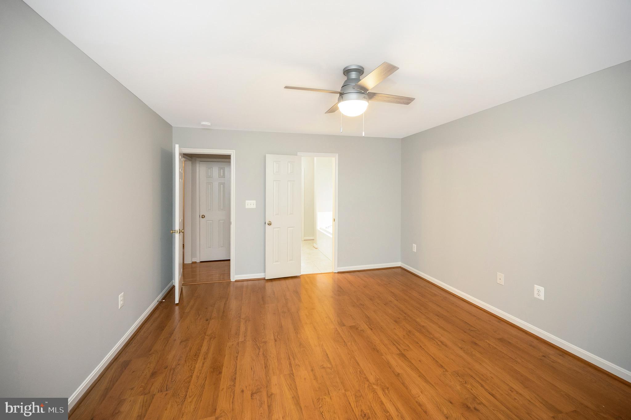 502 Monticello Circle Locust Grove, VA 22508 - Photo 18 of 45 an empty room with wooden floor and fan