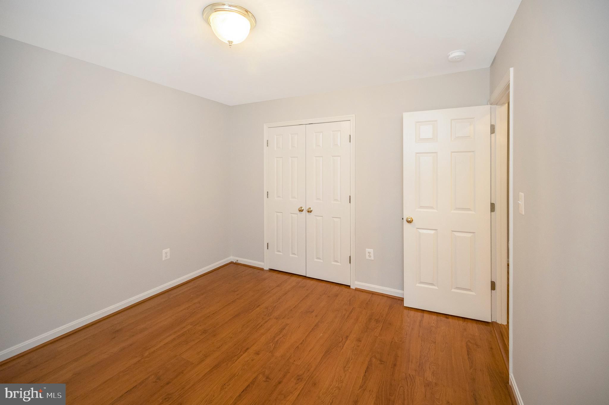 502 Monticello Circle Locust Grove, VA 22508 - Photo 22 of 45 an empty room with wooden floor and windows