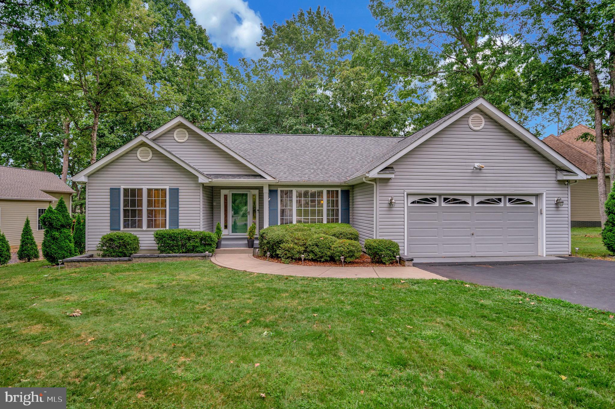 502 Monticello Circle Locust Grove, VA 22508 - Photo 30 of 45 a front view of a house with a yard and garage