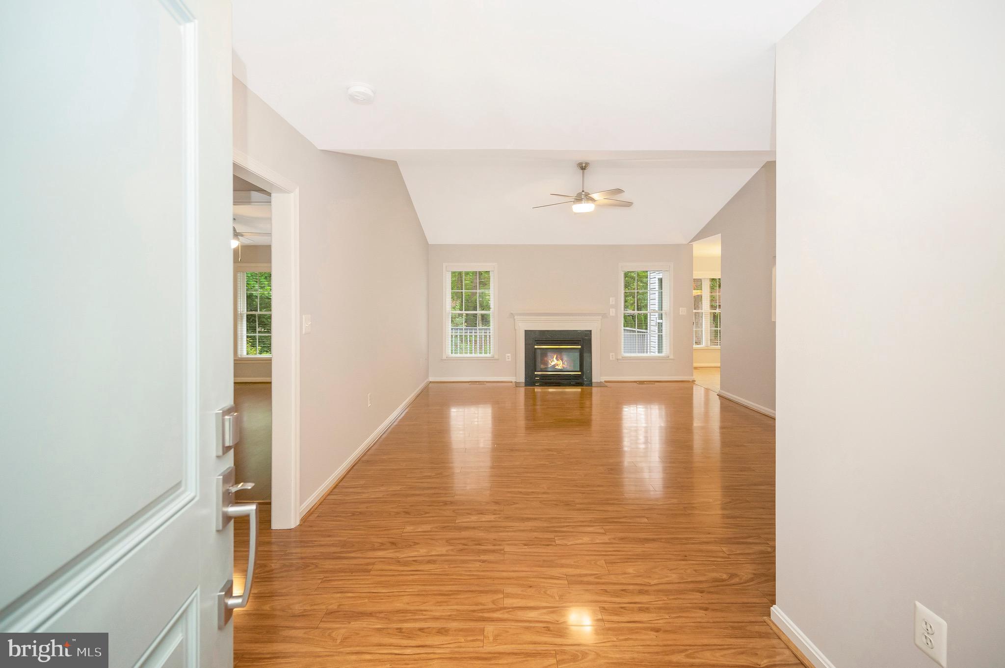 502 Monticello Circle Locust Grove, VA 22508 - Photo 3 of 45 a view of an empty room with wooden floor fireplace and a window