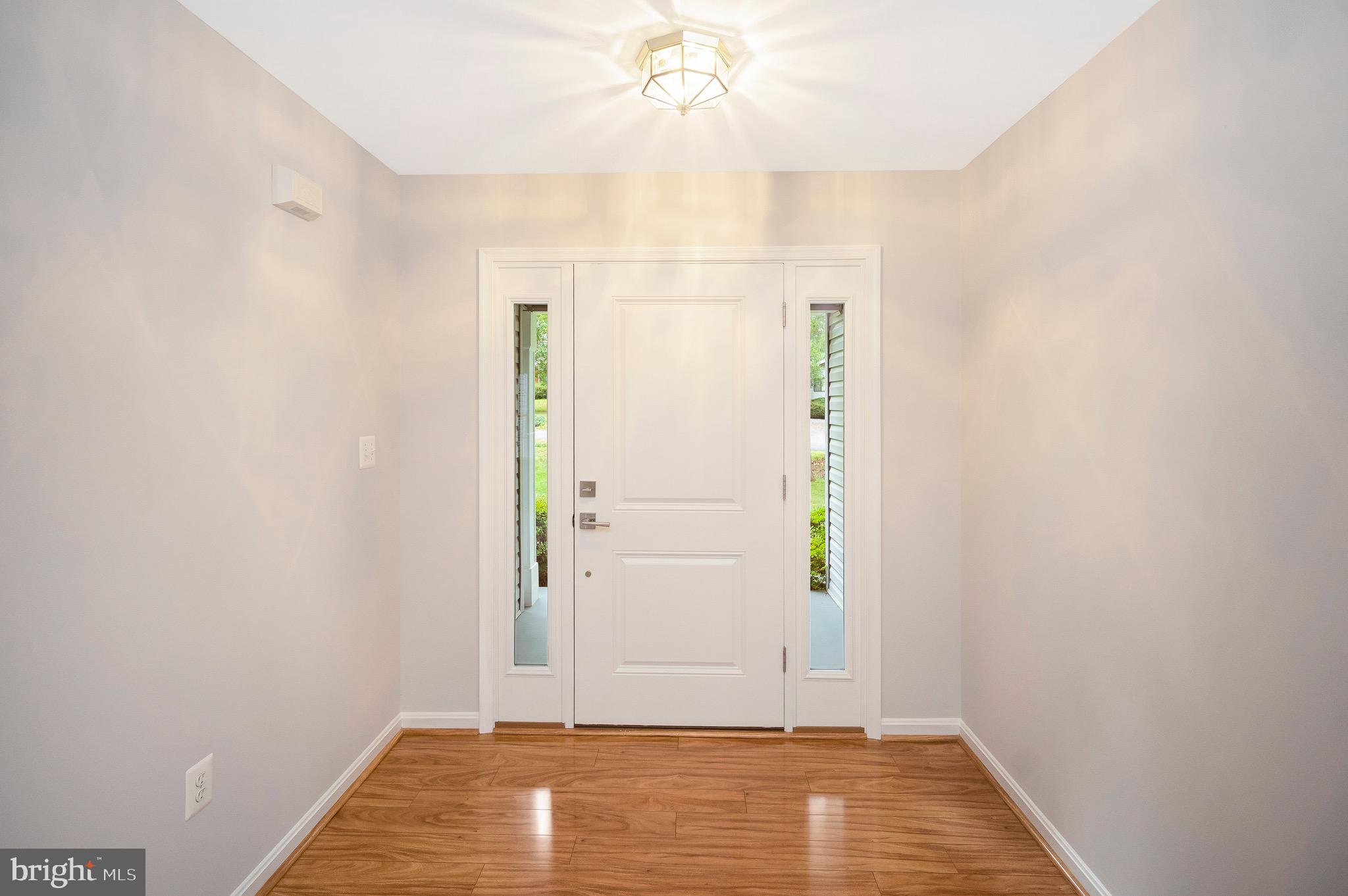502 Monticello Circle Locust Grove, VA 22508 - Photo 4 of 45 an empty room with wooden floor door and fan