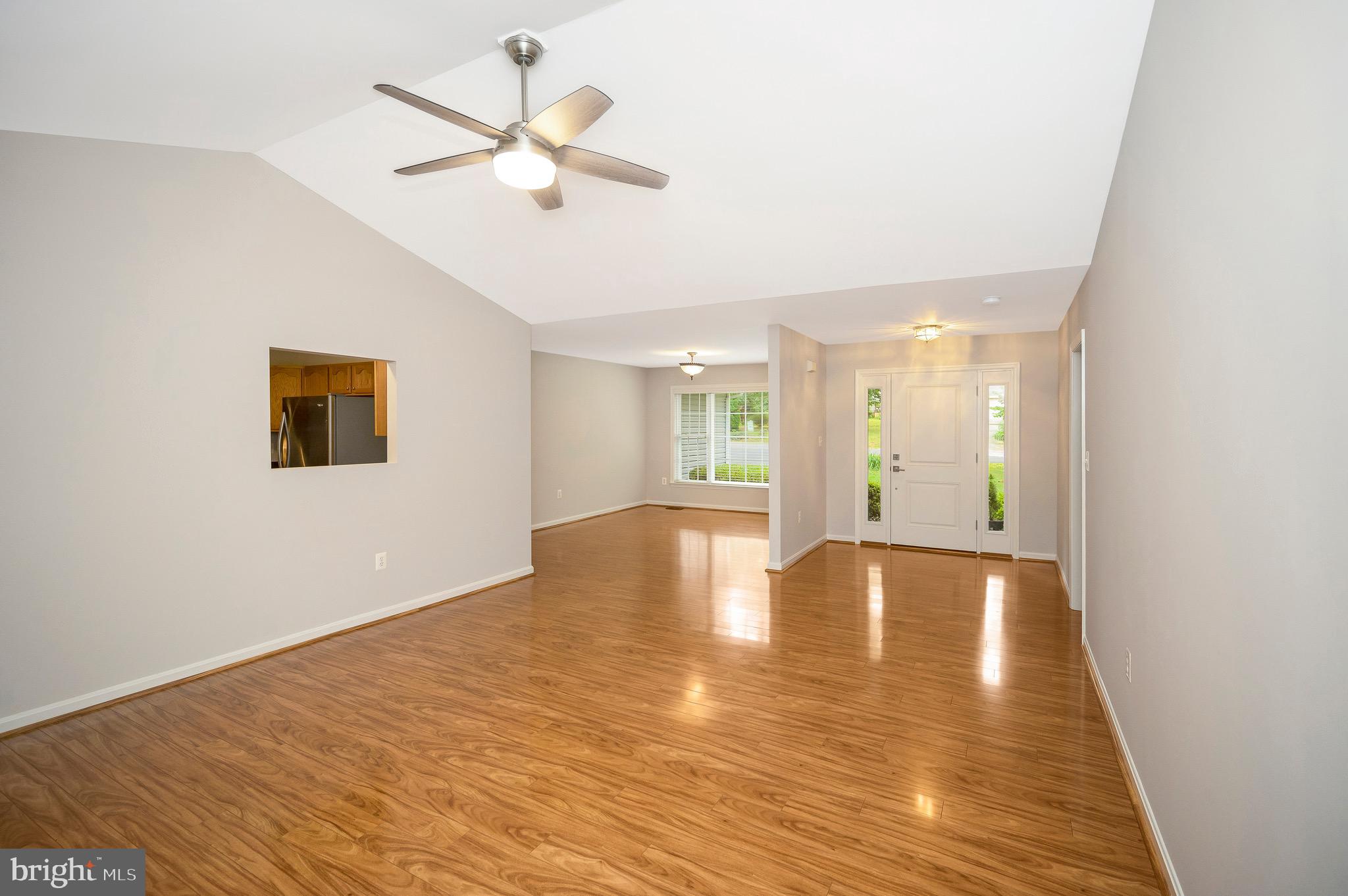 502 Monticello Circle Locust Grove, VA 22508 - Photo 7 of 45 a view of an empty room with wooden floor and a ceiling fan