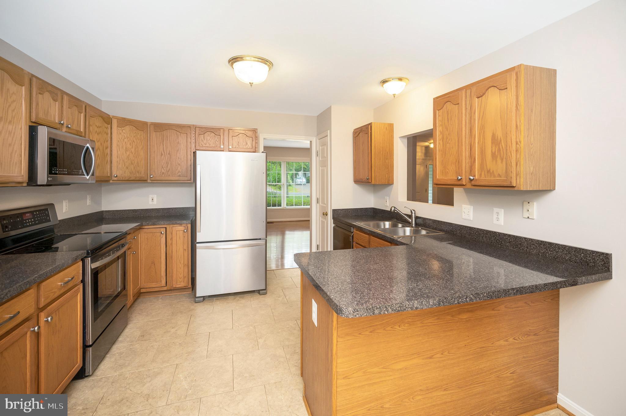 502 Monticello Circle Locust Grove, VA 22508 - Photo 8 of 45 a kitchen with stainless steel appliances granite countertop a sink stove and refrigerator