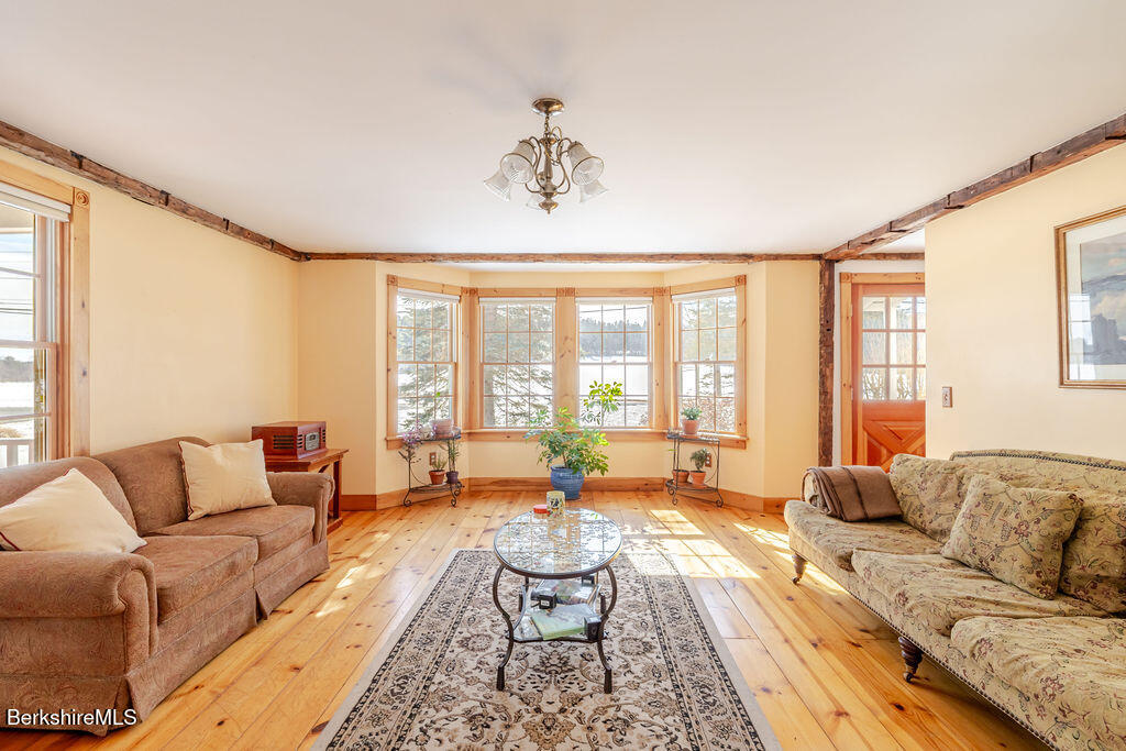 54 Egremont Plain Road Great Barrington, MA 01230 - Photo 12 of 48 a living room with furniture and floor to ceiling windows