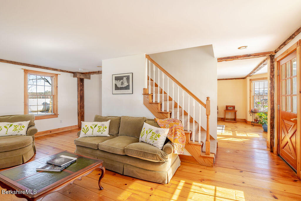 54 Egremont Plain Road Great Barrington, MA 01230 - Photo 16 of 48 a living room with furniture and a table with wooden floor
