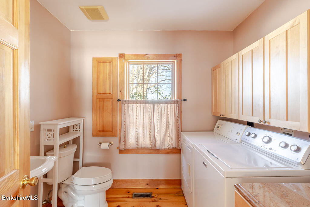54 Egremont Plain Road Great Barrington, MA 01230 - Photo 18 of 48 a bathroom with a sink a toilet and a shower curtain
