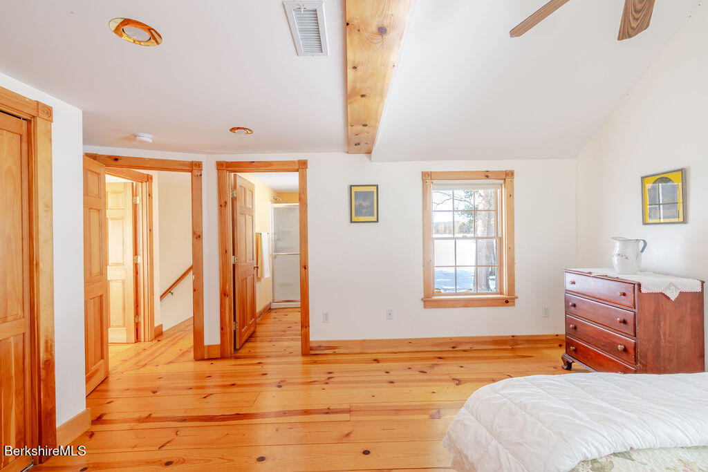 54 Egremont Plain Road Great Barrington, MA 01230 - Photo 24 of 48 a bedroom with a bed and wooden floor