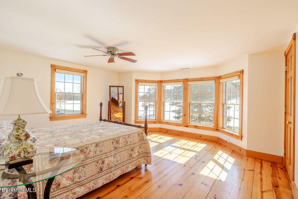 54 Egremont Plain Road Great Barrington, MA 01230 - Photo 27 of 48 a spacious bedroom with a large bed and a large window