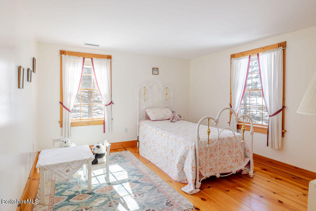 54 Egremont Plain Road Great Barrington, MA 01230 - Photo 32 of 48 a bed sitting in a bedroom next to a window