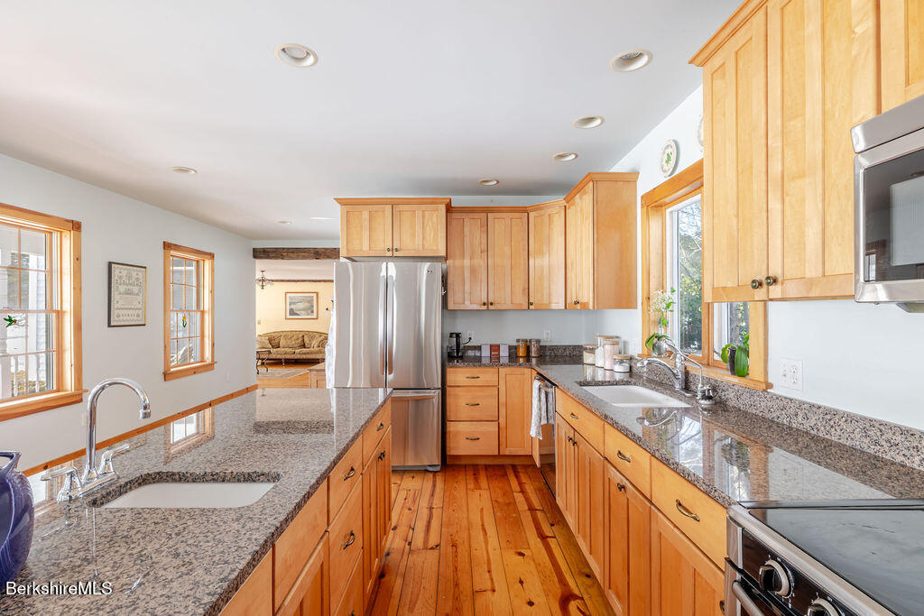 54 Egremont Plain Road Great Barrington, MA 01230 - Photo 4 of 48 a large kitchen with granite countertop a large window and a counter space