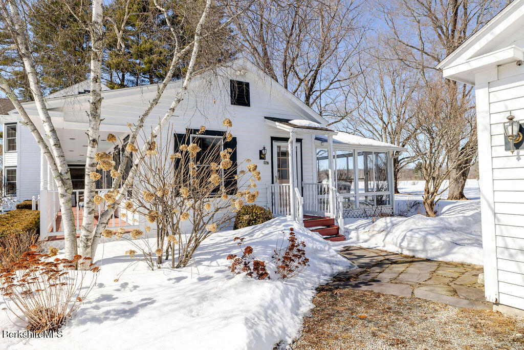 54 Egremont Plain Road Great Barrington, MA 01230 - Photo 43 of 48 a view of a white house with a yard covered in snow