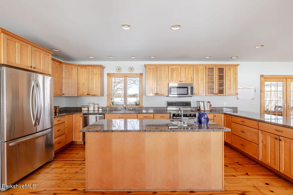 54 Egremont Plain Road Great Barrington, MA 01230 - Photo 5 of 48 a kitchen with stainless steel appliances granite countertop a refrigerator a stove top oven a sink and dishwasher a refrigerator