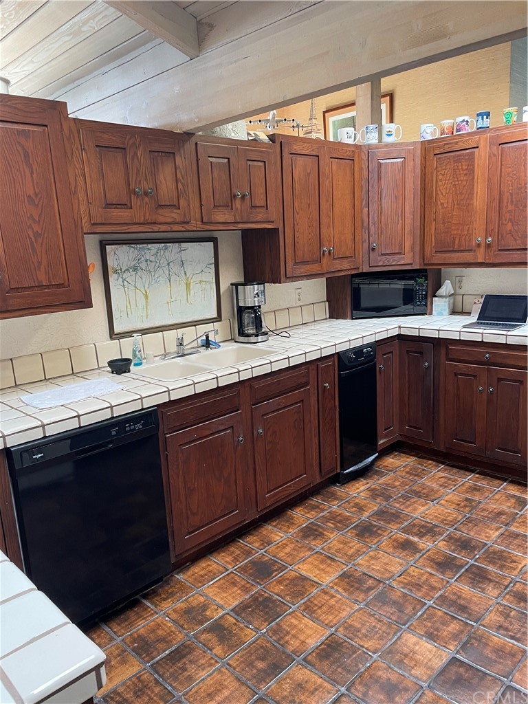 32592 Balearic Dana Point, CA 92629 - Photo 12 of 26 a kitchen with a sink a stove and cabinets