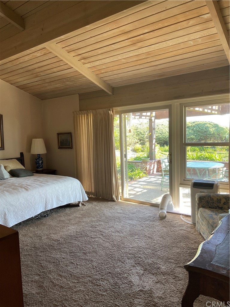 32592 Balearic Dana Point, CA 92629 - Photo 13 of 26 a bedroom with a bed and large windows