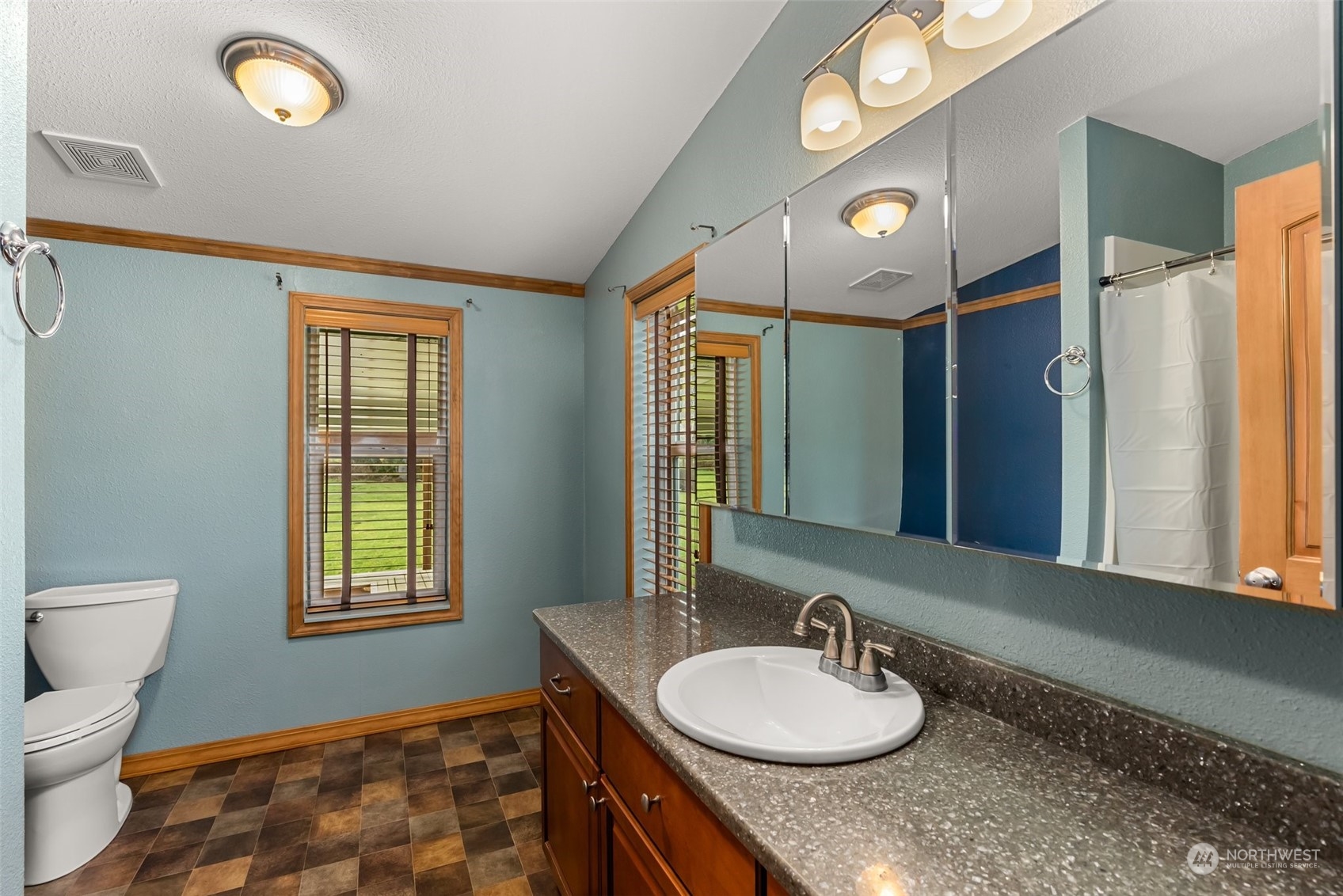 47 Zowadski Road Raymond, WA 98577 - Photo 21 of 40 a bathroom with a granite countertop sink and a mirror