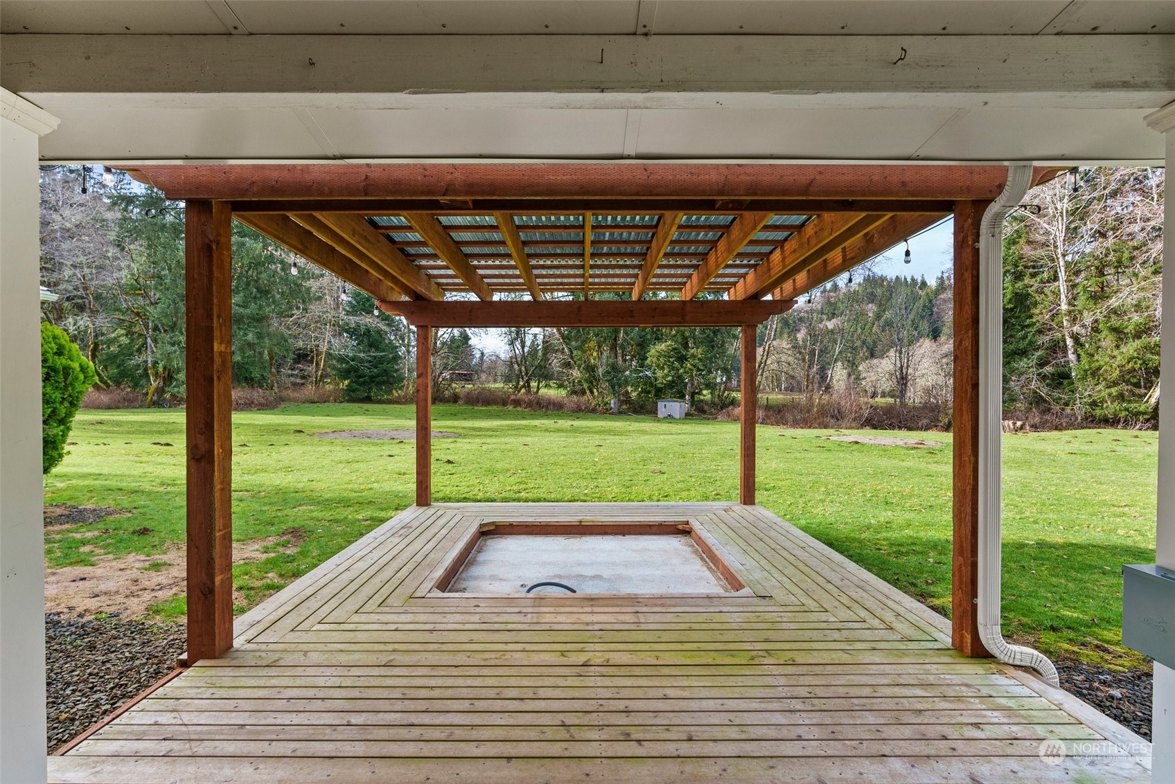 47 Zowadski Road Raymond, WA 98577 - Photo 30 of 40 a view of a deck with wooden floor and roof with a garden view