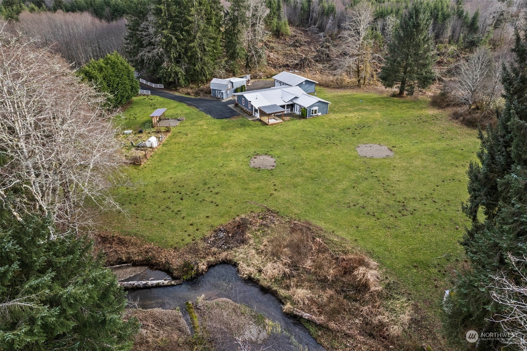 47 Zowadski Road Raymond, WA 98577 - Photo 8 of 40 a backyard of a house with a yard and outdoor seating