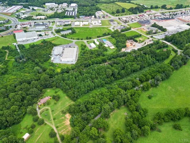 an aerial view of a residential houses with outdoor space and street view