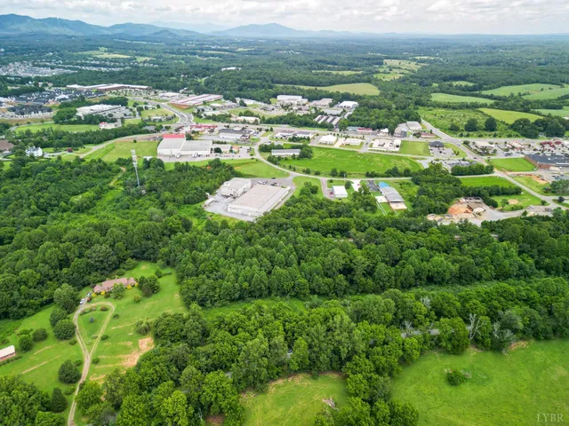 a view of a green field with lots of bushes