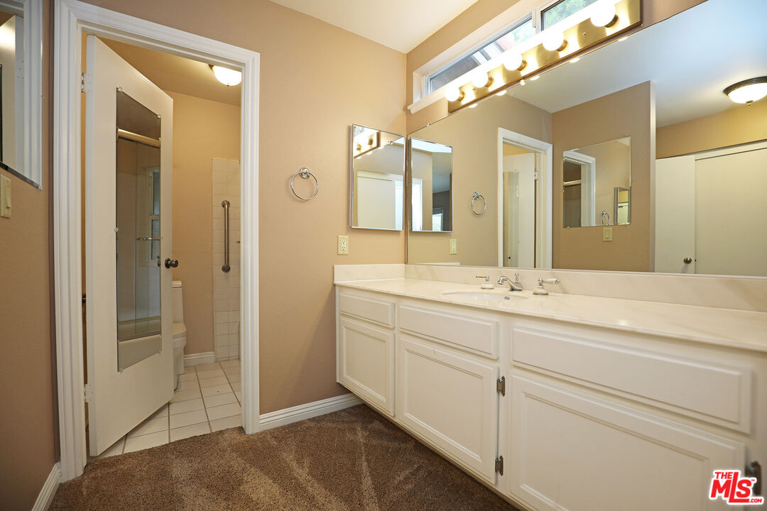 3415 Circle View Drive Simi Valley, CA 93063 - Photo 24 of 37 a bathroom with a double vanity sink and a mirror