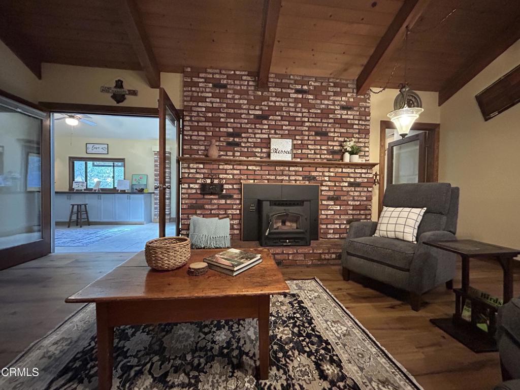 51793 Quail Ridge Road Oakhurst, CA 93644 - Photo 25 of 70 a living room with furniture and a fireplace