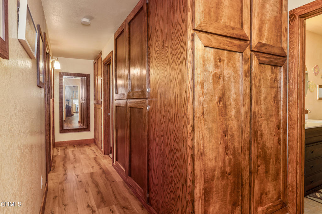 51793 Quail Ridge Road Oakhurst, CA 93644 - Photo 42 of 70 a view of a hallway with wooden floor