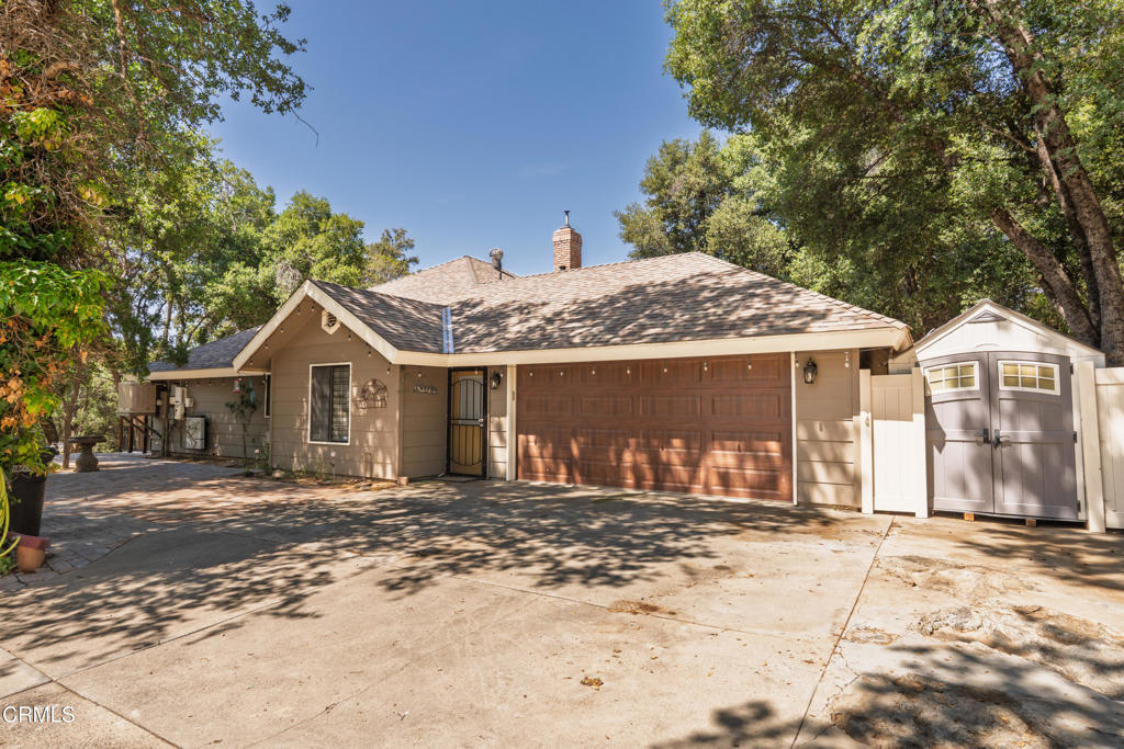 51793 Quail Ridge Road Oakhurst, CA 93644 - Photo 46 of 70 a front view of a house with a dirt yard