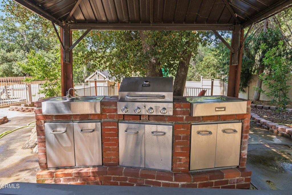 51793 Quail Ridge Road Oakhurst, CA 93644 - Photo 56 of 70 a kitchen with stainless steel appliances granite countertop a stove a sink and a white wooden cabinets