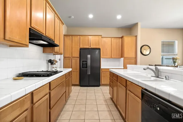 a kitchen with stainless steel appliances a refrigerator and a stove