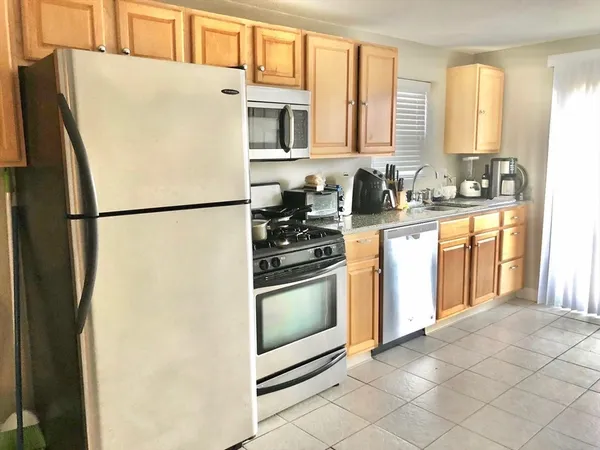 a white refrigerator freezer sitting inside of a kitchen