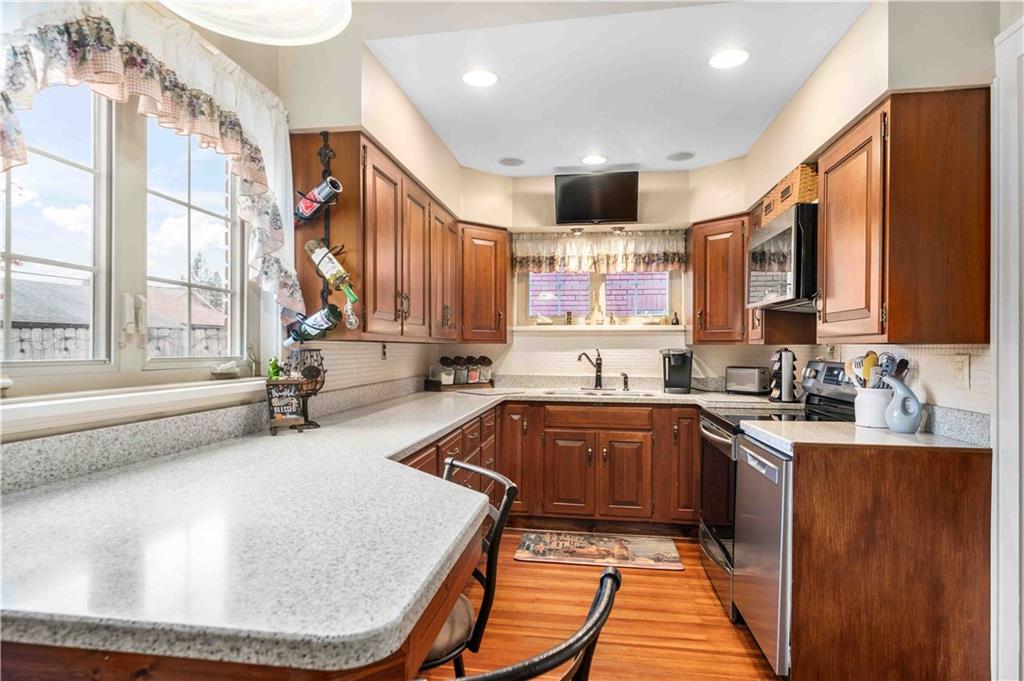 201 4th Street Beaver, PA 15009 - Photo 15 of 50 a kitchen with a sink a stove and cabinets