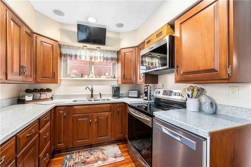 201 4th Street Beaver, PA 15009 - Photo 17 of 50 a kitchen with stainless steel appliances granite countertop a sink stove and microwave