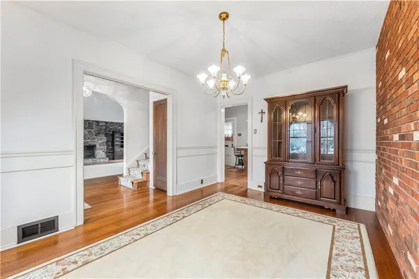 a living room with hard wood floors and a fireplace