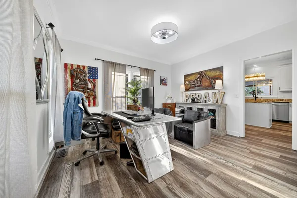 a view of a workspace with furniture and a kitchen