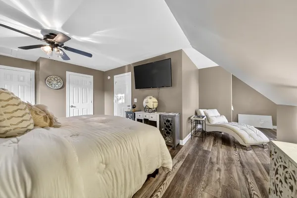 a bedroom with bed and a flat tv screen