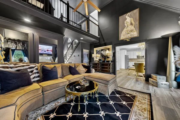 a living room with furniture a rug and outdoor seating