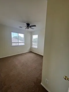 an empty room with a empty space and a ceiling fan