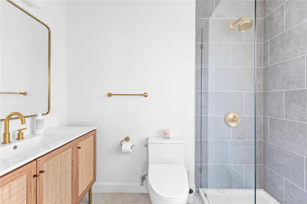 a bathroom with a sink a toilet and shower