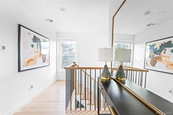 a view of hallway with furniture and a window