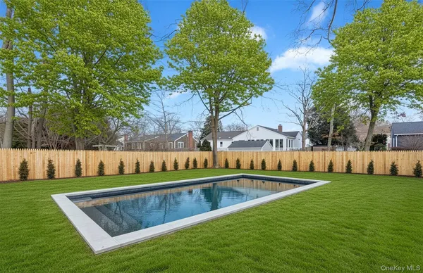 a view of yard with swimming pool and green space