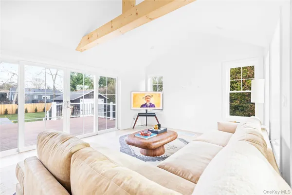 a bedroom with furniture and a large window