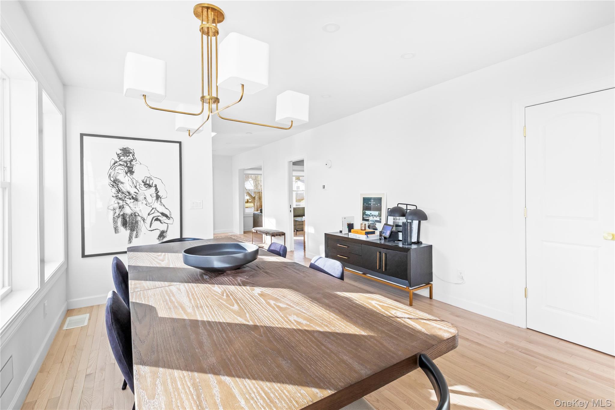 21 North Howells Point Road Bellport, NY 11713 - Photo 10 of 21 a living room with furniture and a chandelier