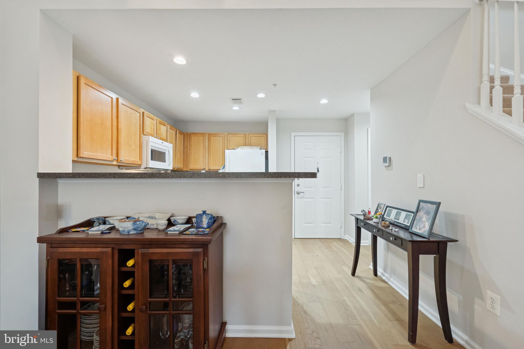 12000 Market Street, Unit 445 Reston, VA 20190 - Photo 6 of 51 a view of a room with furniture and wooden floor